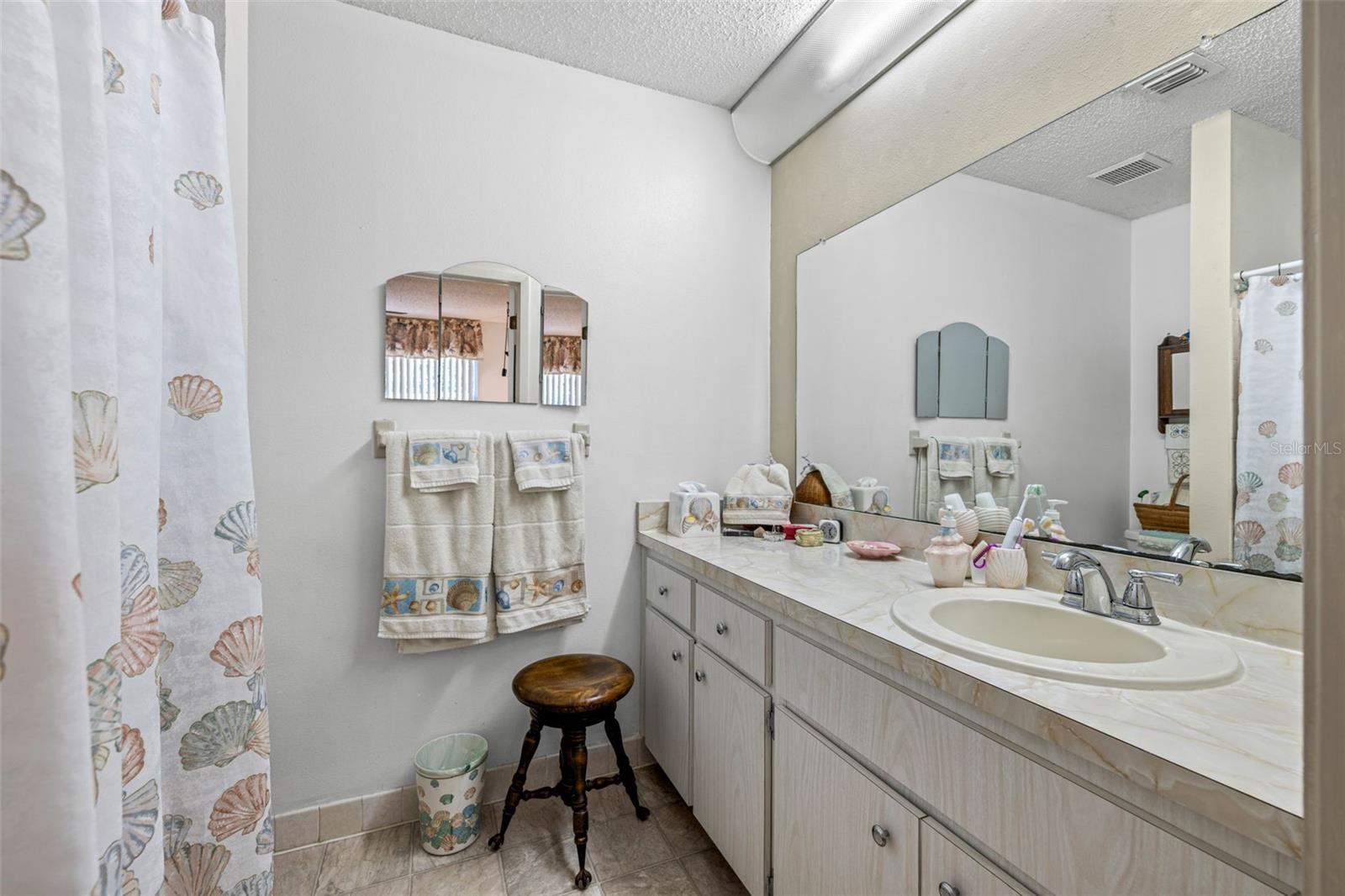 The Primary bathroom features a large vanity and walk-in shower (no tub)