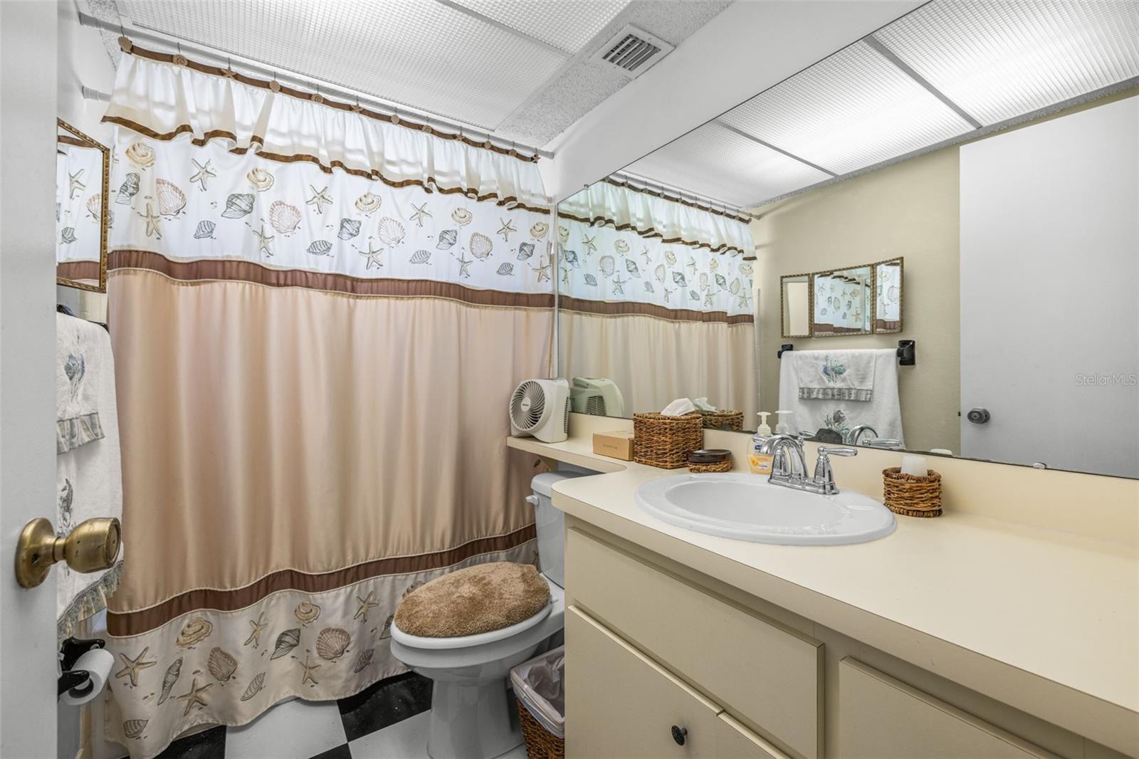 Secondary bathroom features a tub/shower combination.