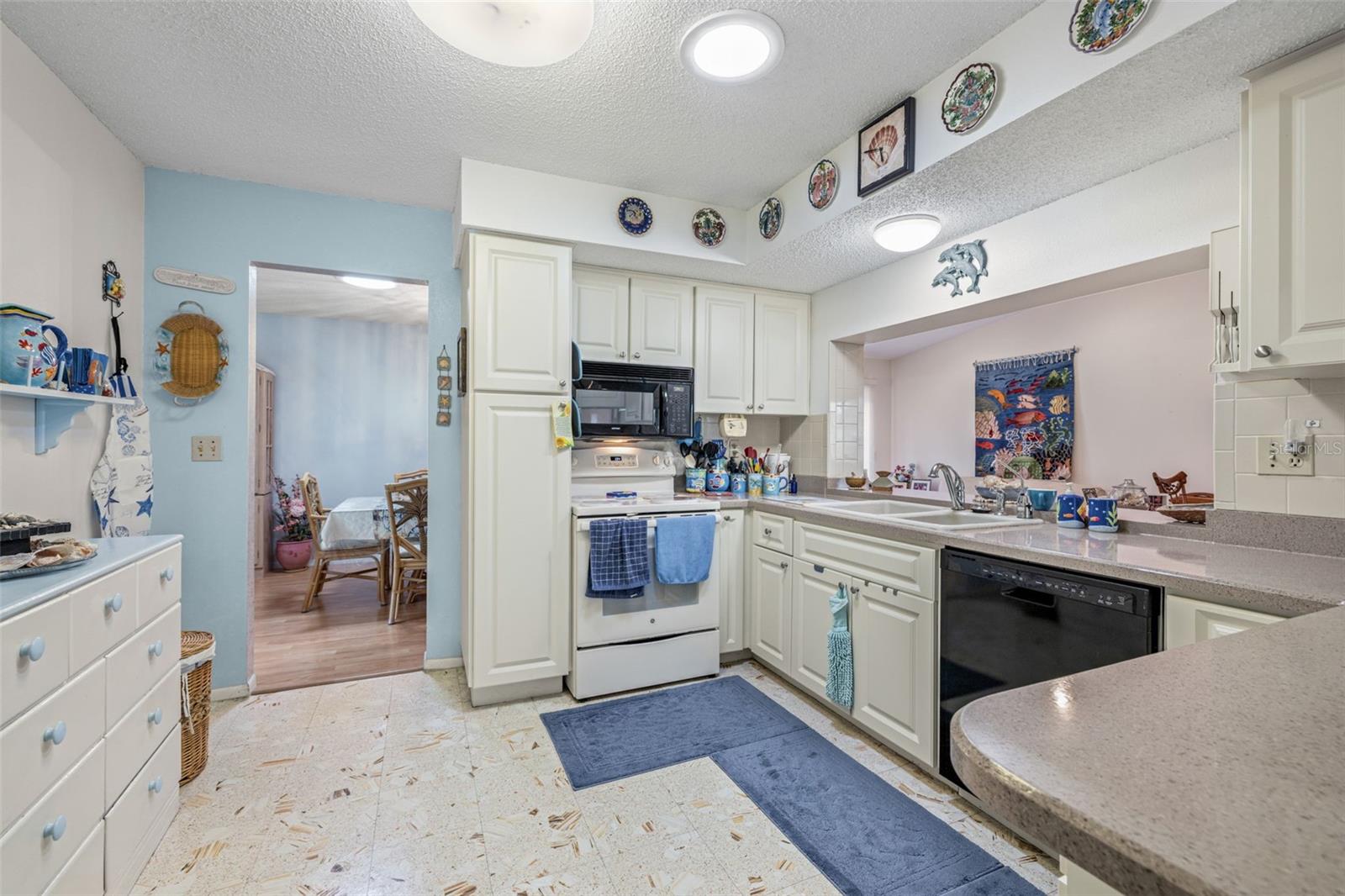 The kitchen features updated cabinetry and Corian counter tops. Another solar tube in the kitchen keeps everything bright with natural light!