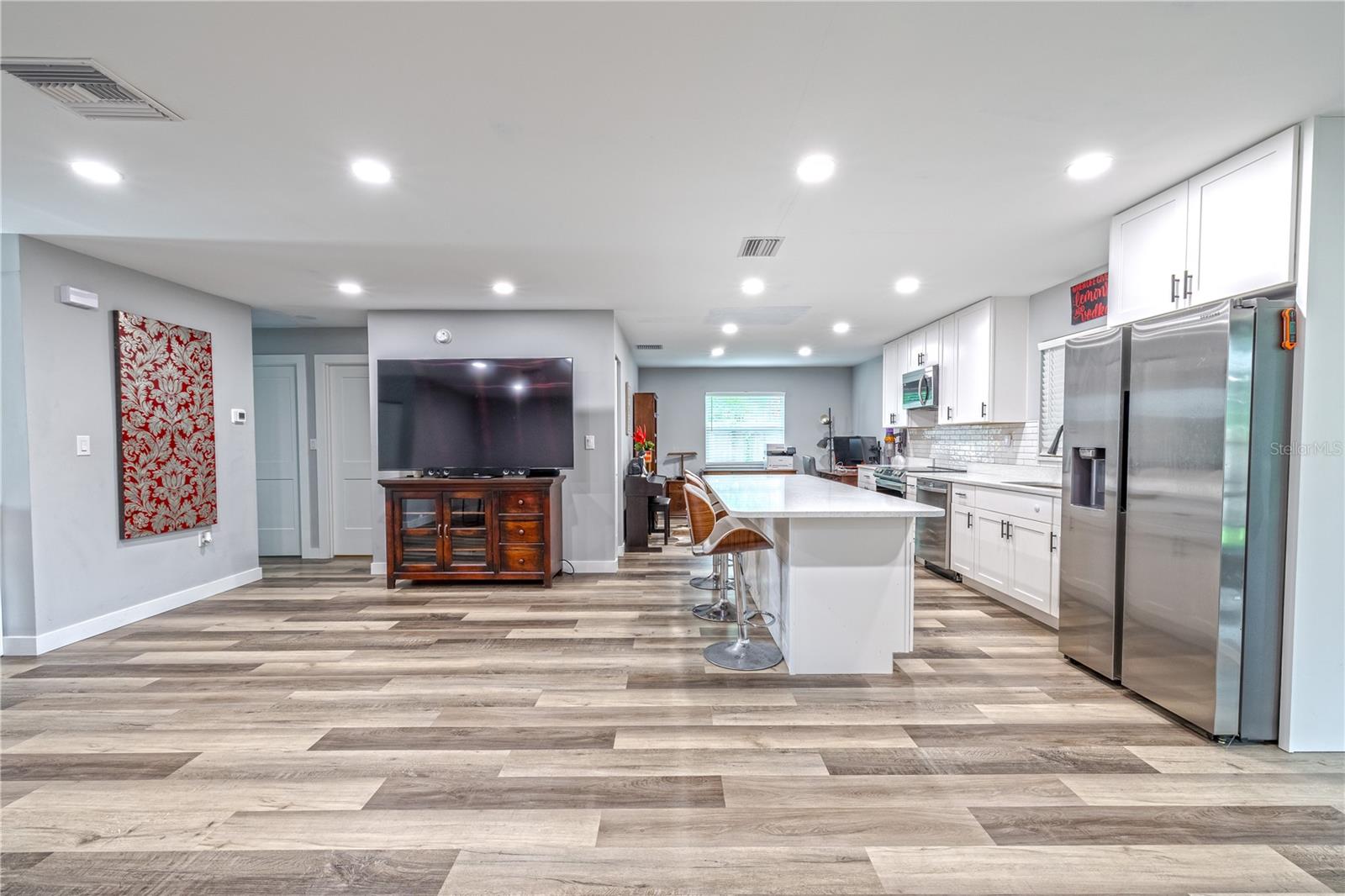 Wide-angle view of the open floor plan, showcasing natural flow between rooms.