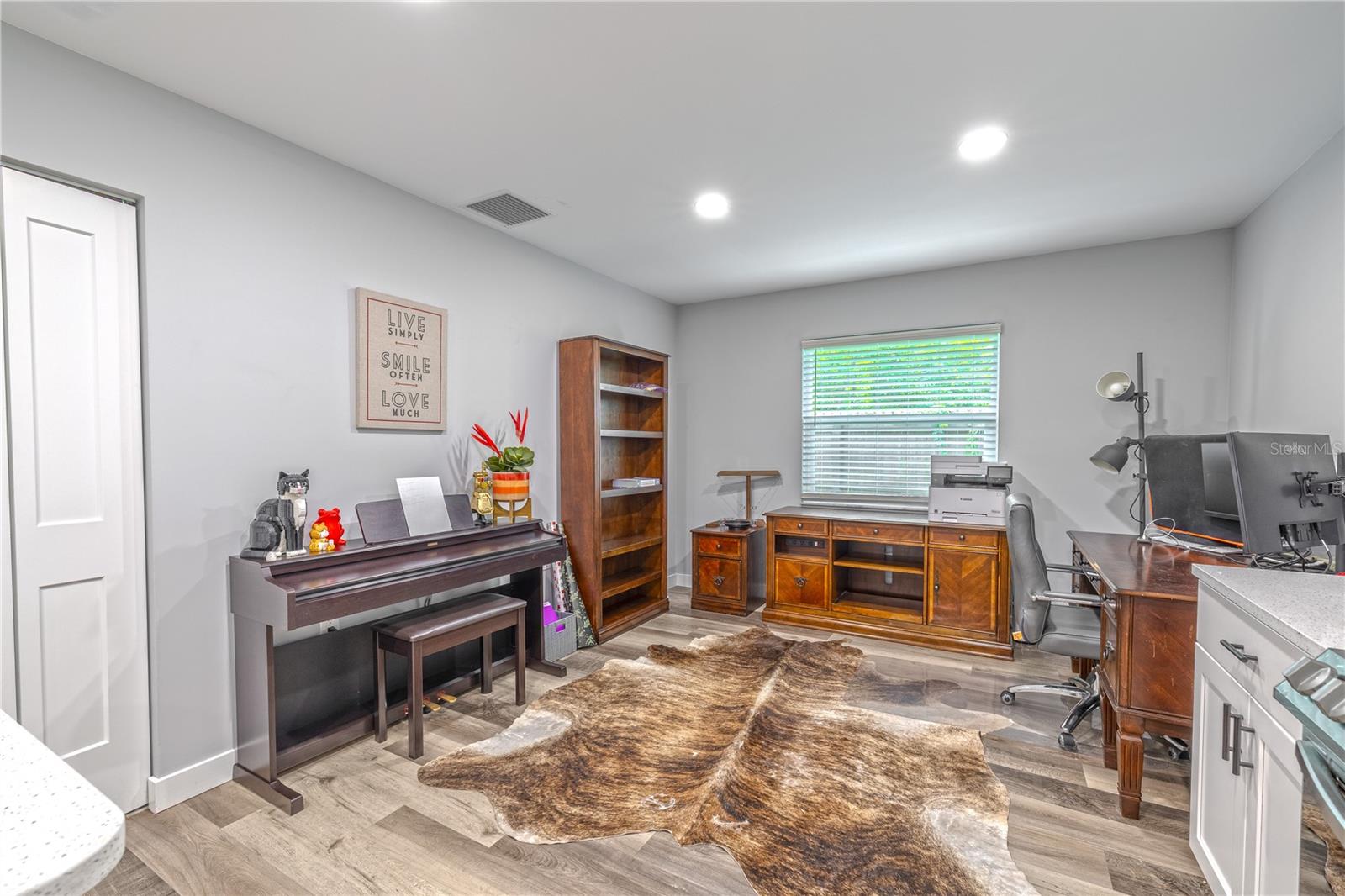 Versatile flex space off the kitchen, ideal for dining, a music area, office, or reading nook.