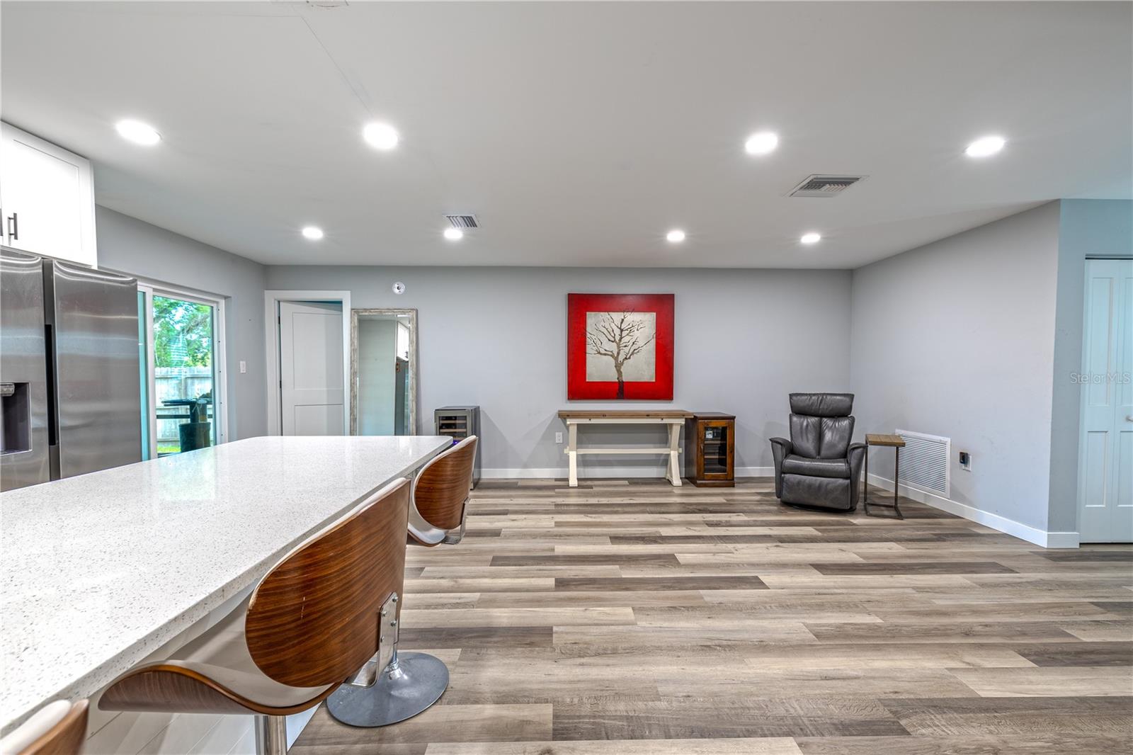 Bright kitchen with expansive island seating, quartz countertops, and modern finishes.