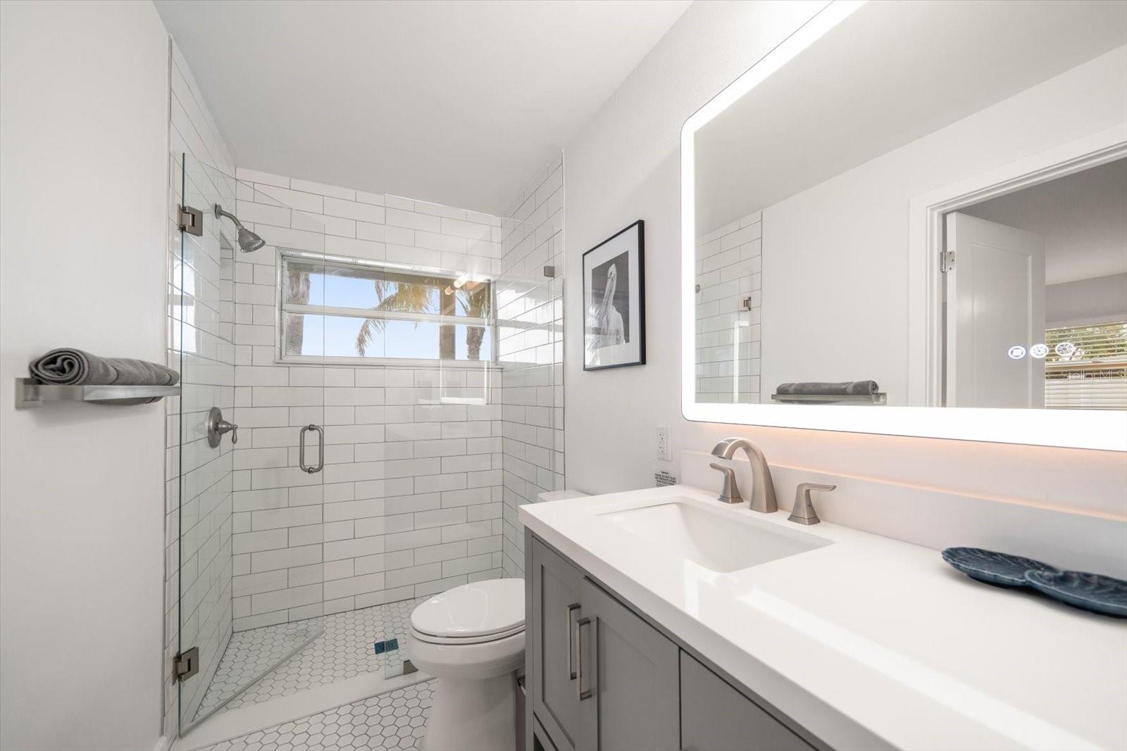 Attractive primary bath with walk in shower and impressive finishings.