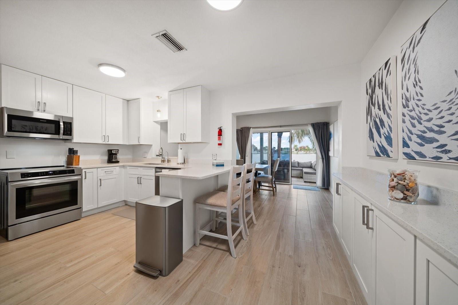 Love this kitchen where everyone congregates. Attractive center island and built in adjacent cupboards, this NEW kitchen is easy to enjoy.