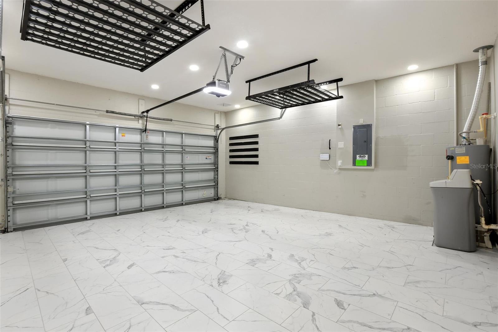 A dream garage equipped with overhead storage racks, Kobalt wall system, & 12 flush mount can-less lights!