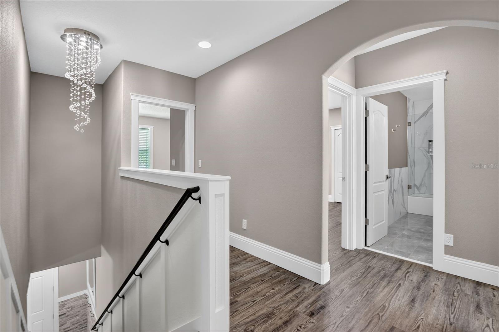 A dazzling chandelier overlooks the staircase & second floor.
