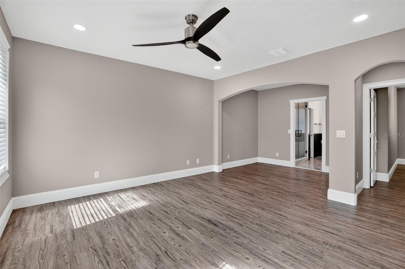 The primary bedroom also features 4 color-changing, flush mounted can-less lights & modern ceiling fan.