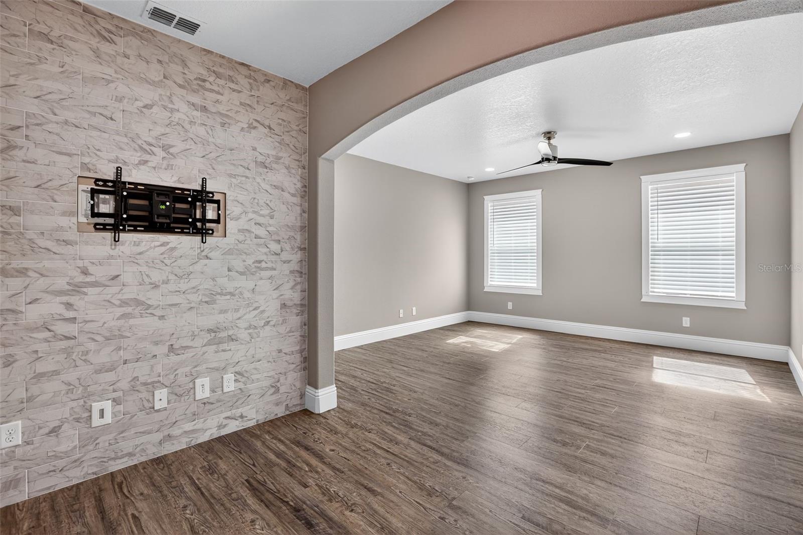 Marble-look tile in primary suite seating area with hidden outlets.