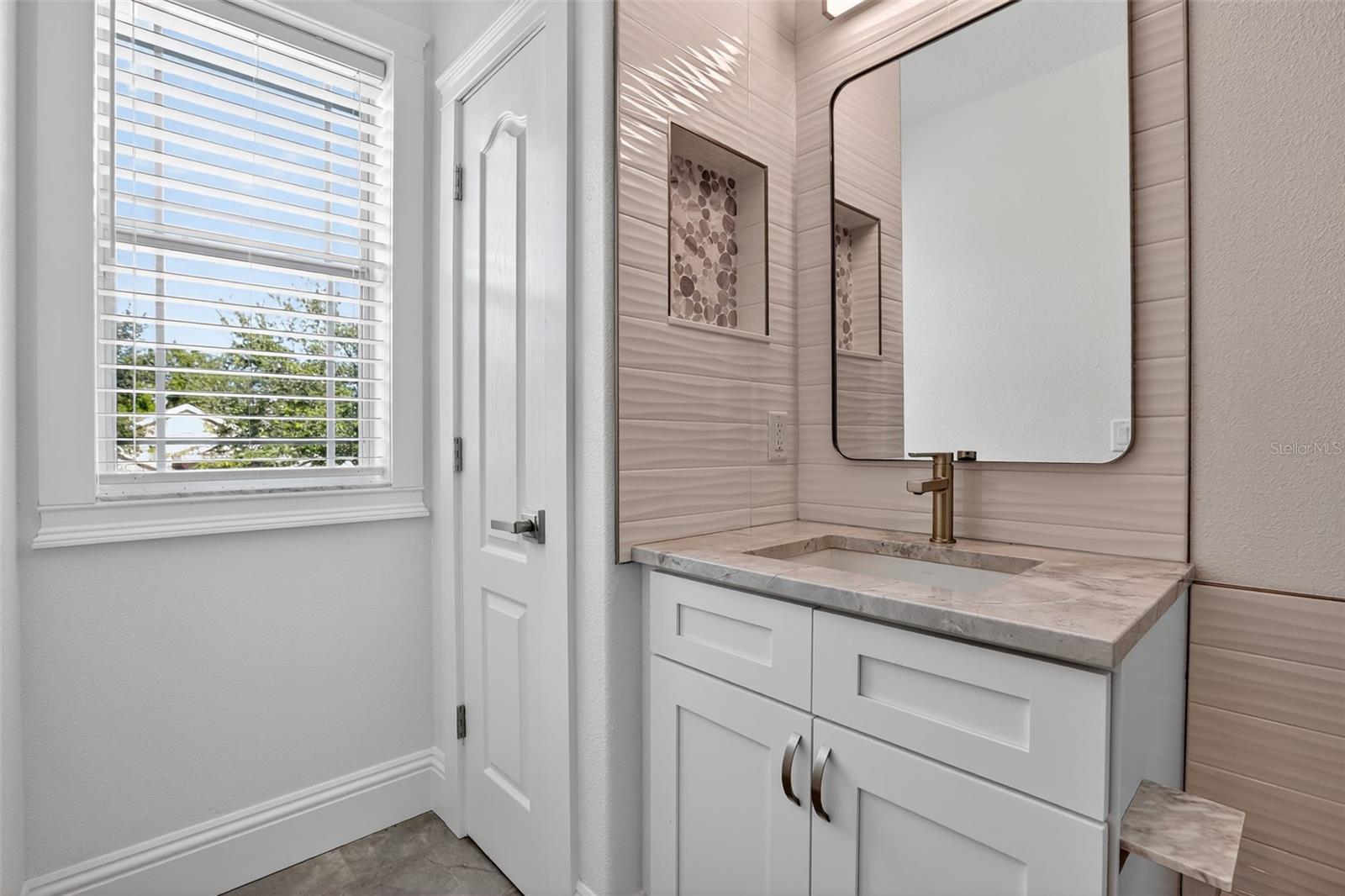 Storage closet features custom built-in shelving too!