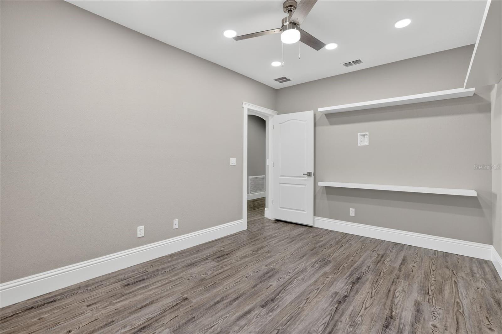 With tons of shelving & more hidden tv outlets, this room could work for many purposes.