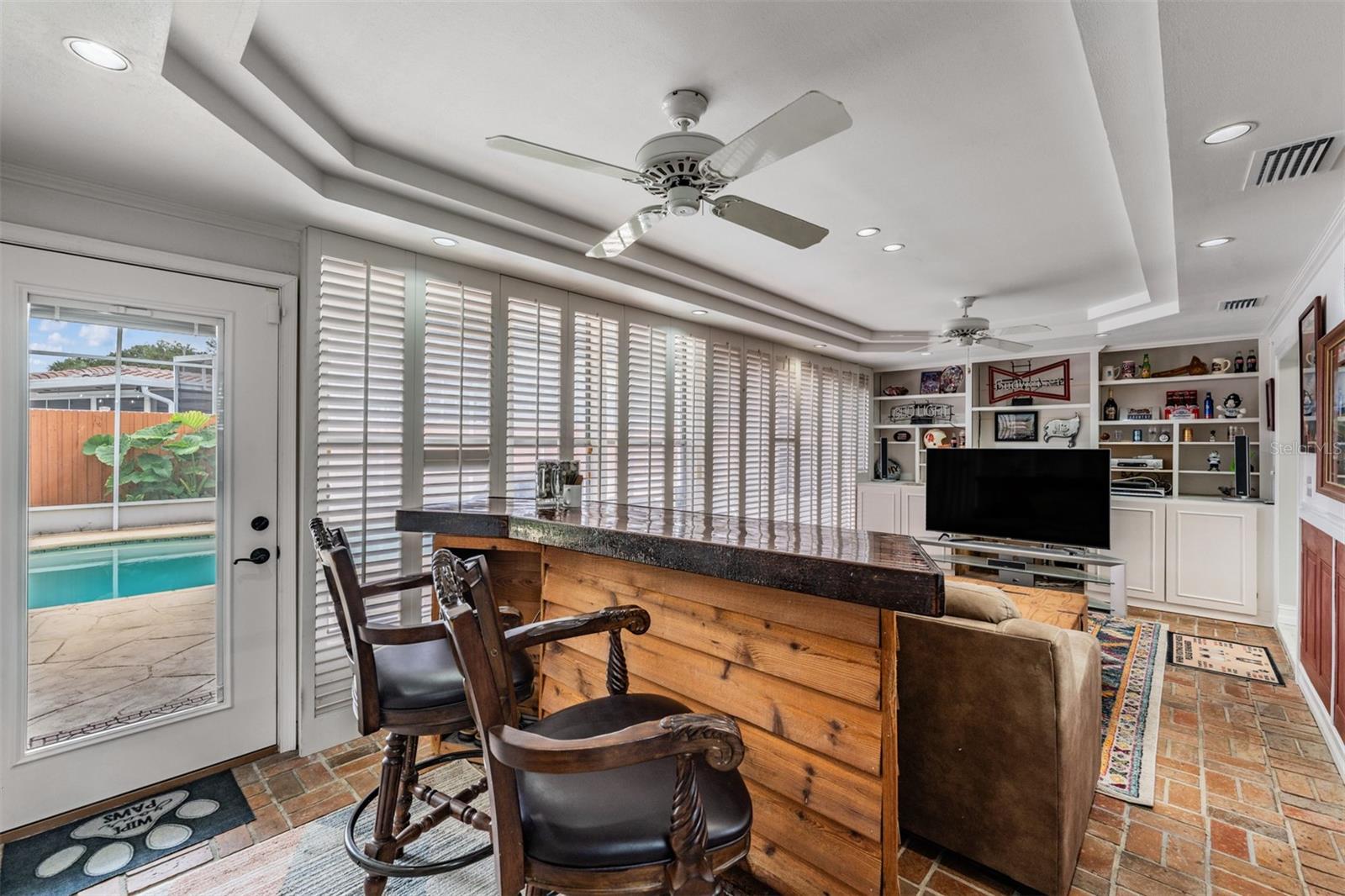 Family room with tray ceilings and fans