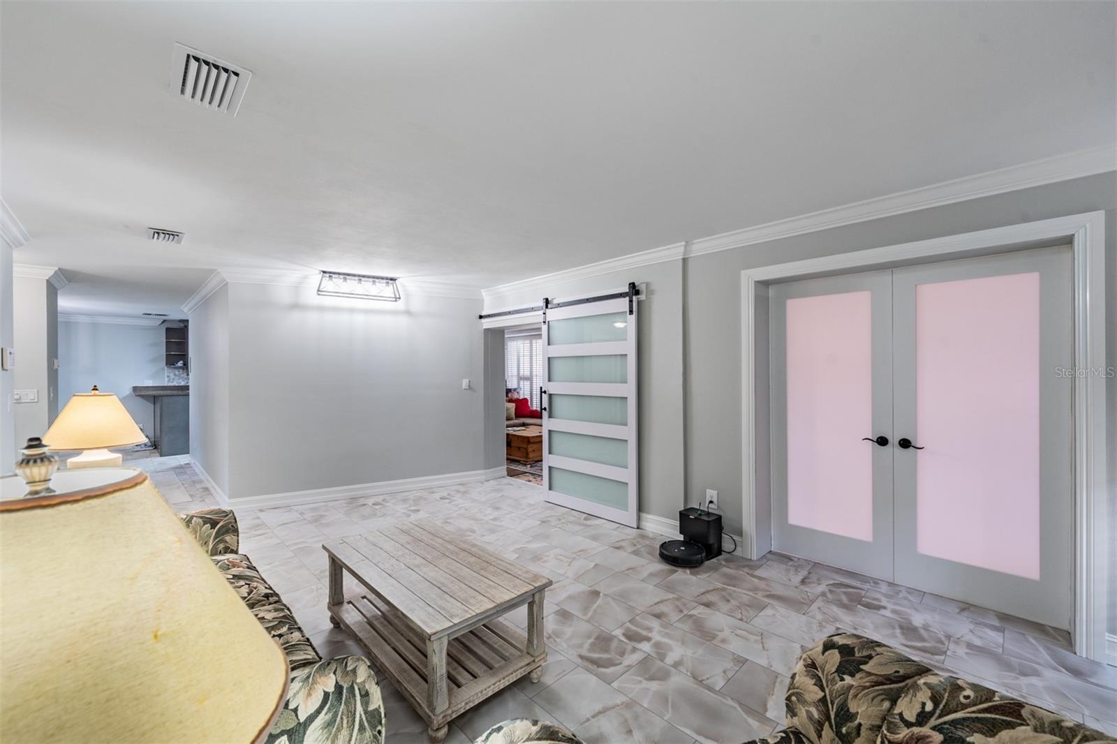 Living room with den and family room access