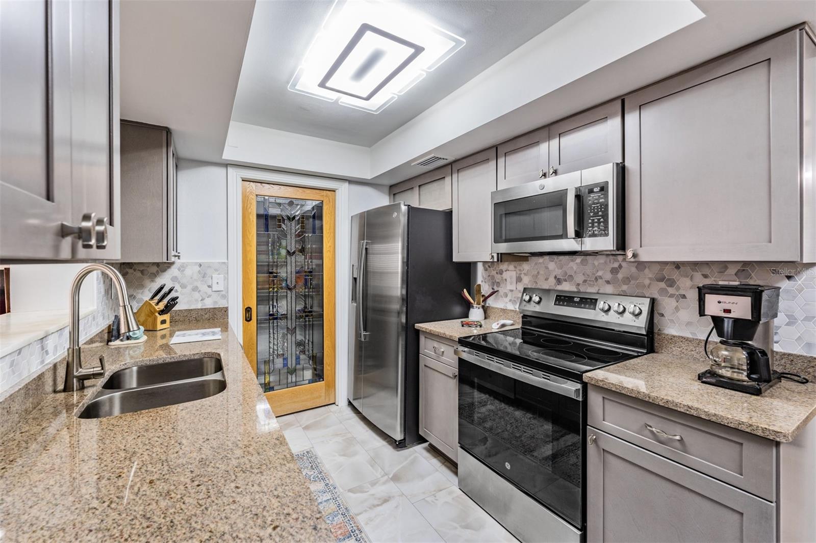 Updated kitchen with custom lead glass door