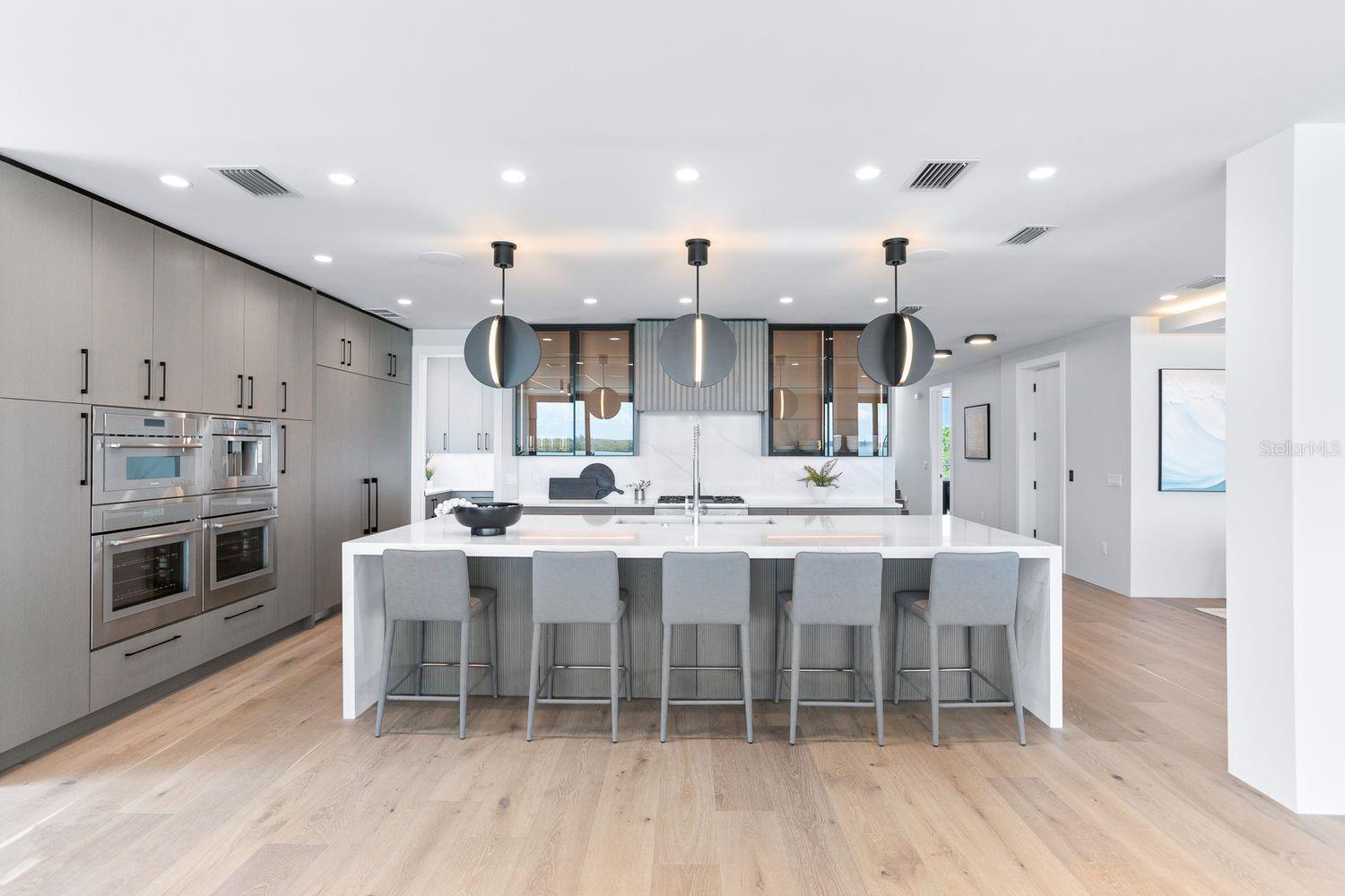 Pristine Kitchen Anchored by a Magnificent Waterfall Island