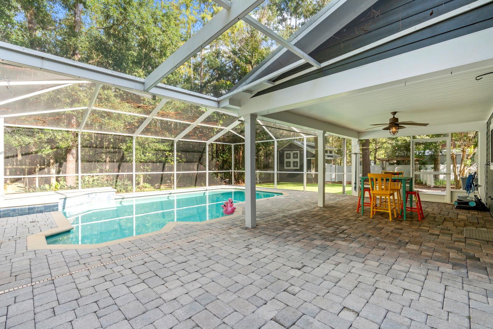 Enclosed caged pool with pavers