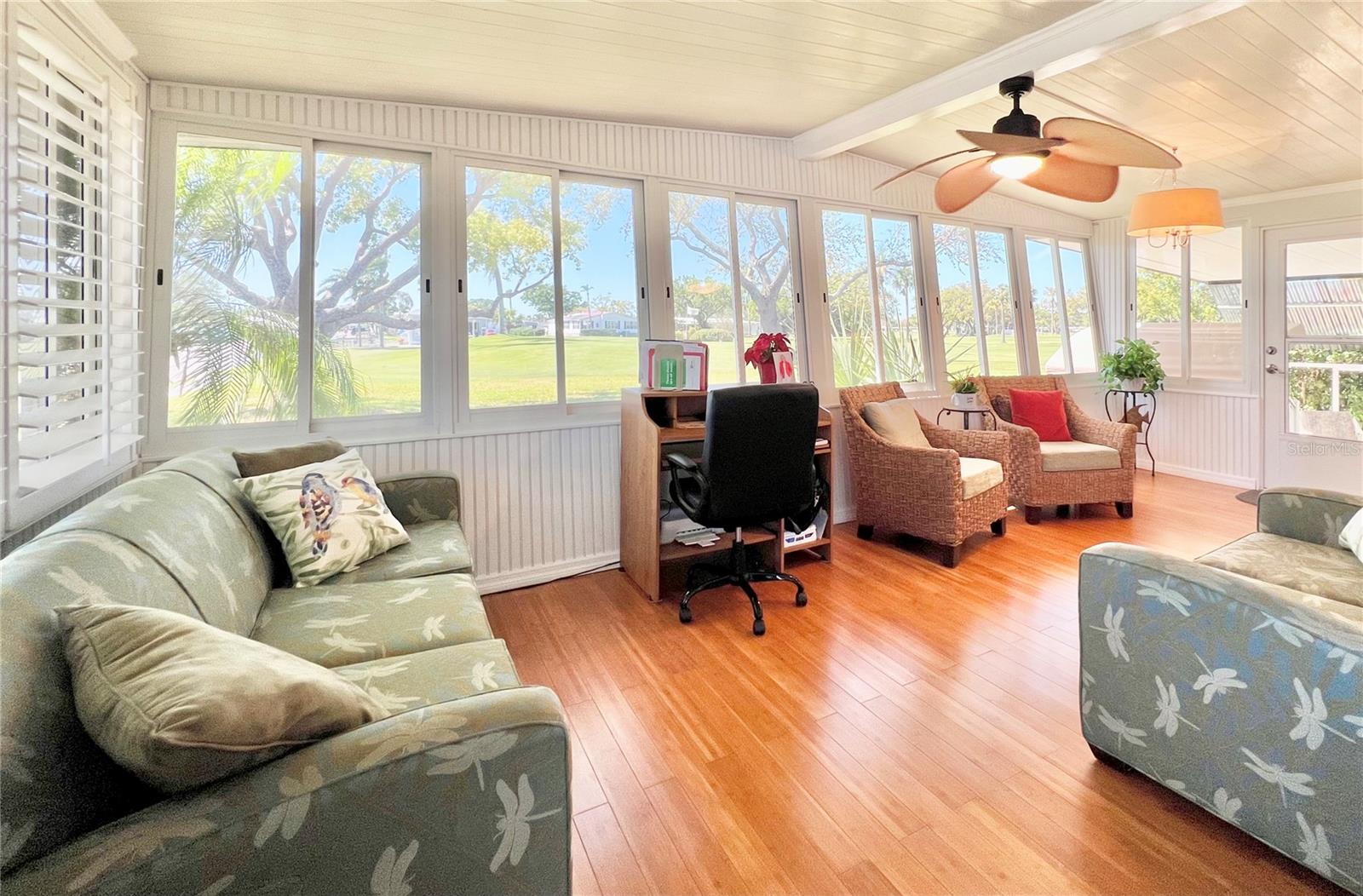 Florida room/office area with view of golf course