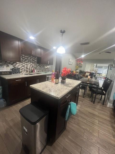 Beautifully designed backsplash in kitchen with granite countertop island.