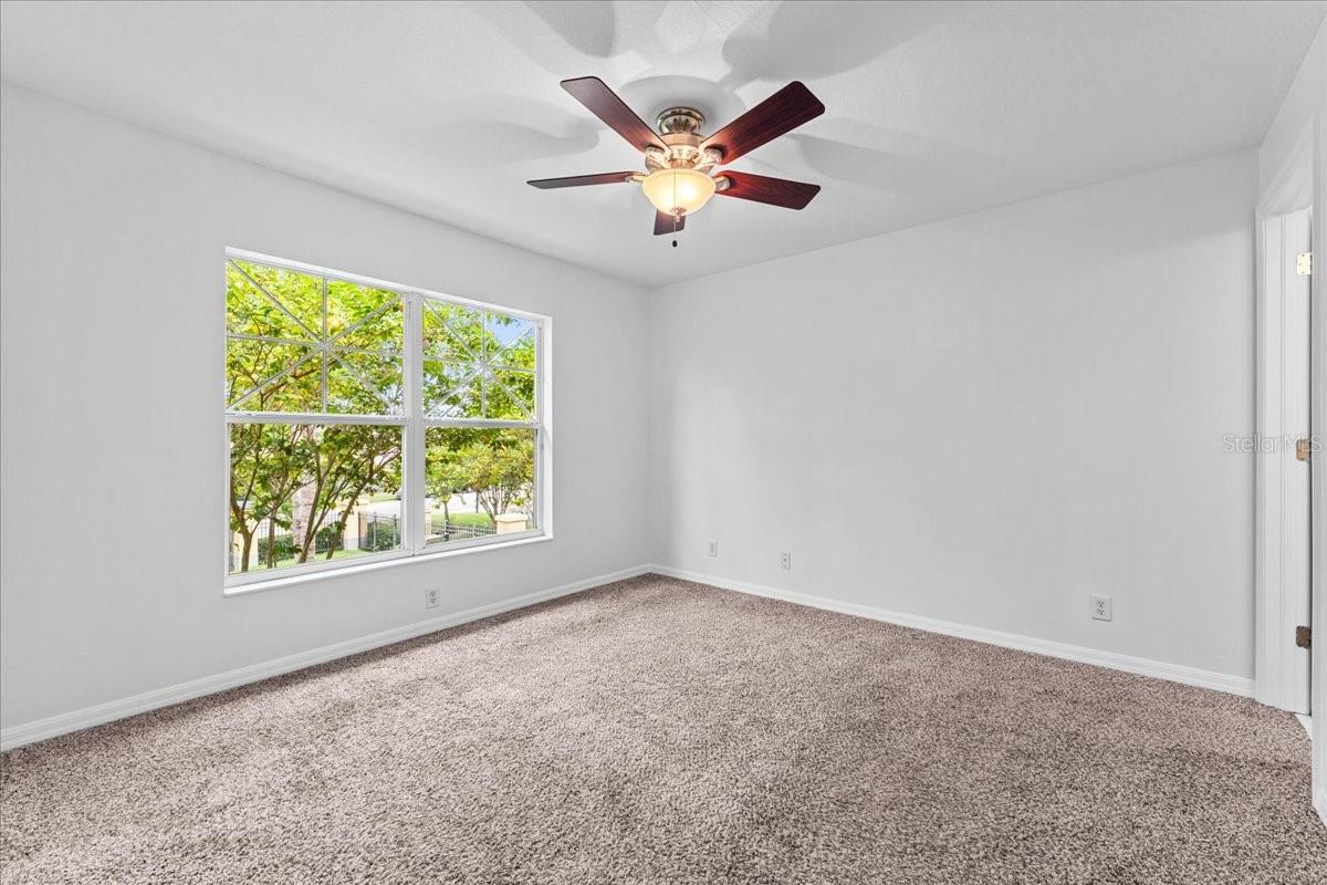 Ceiling fan in the primary bedroom helps with energy bills