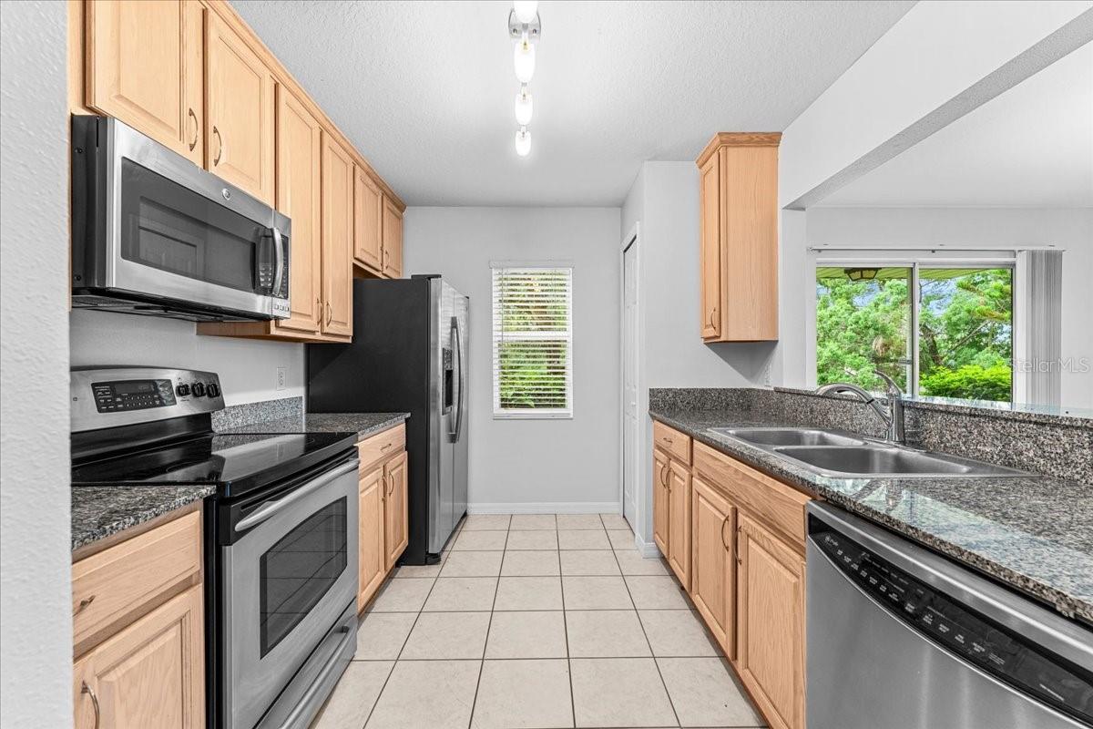 Open kitchen with nice stainless stell appliances