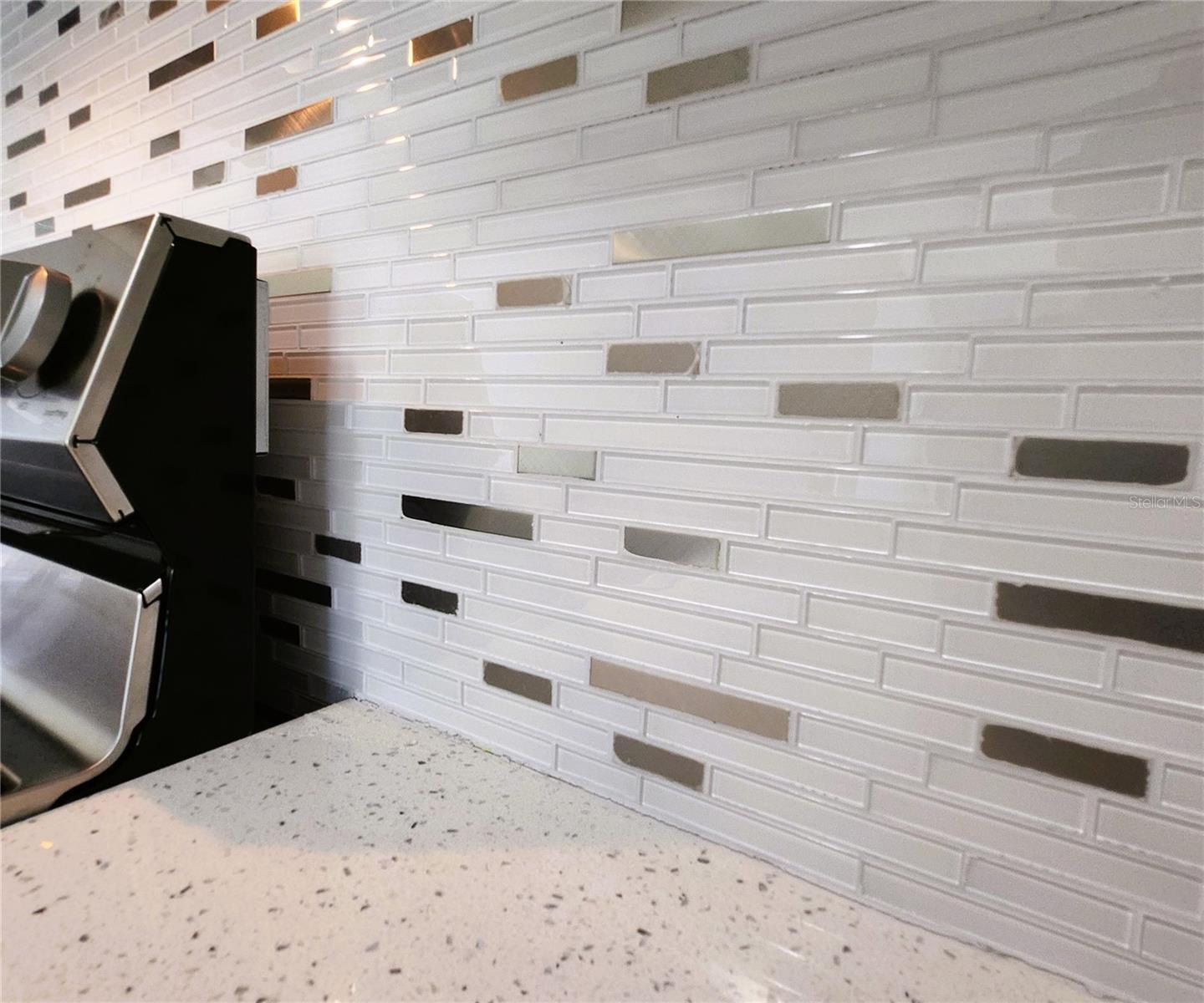 Kitchen includes granite countertops,  backsplash, new refrigerator, new stove, new microwave
