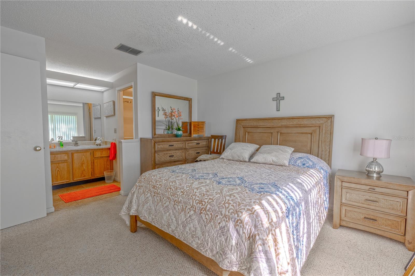 Another view of the spacious primary suite, offering flexible layout options and direct access to the private bath.