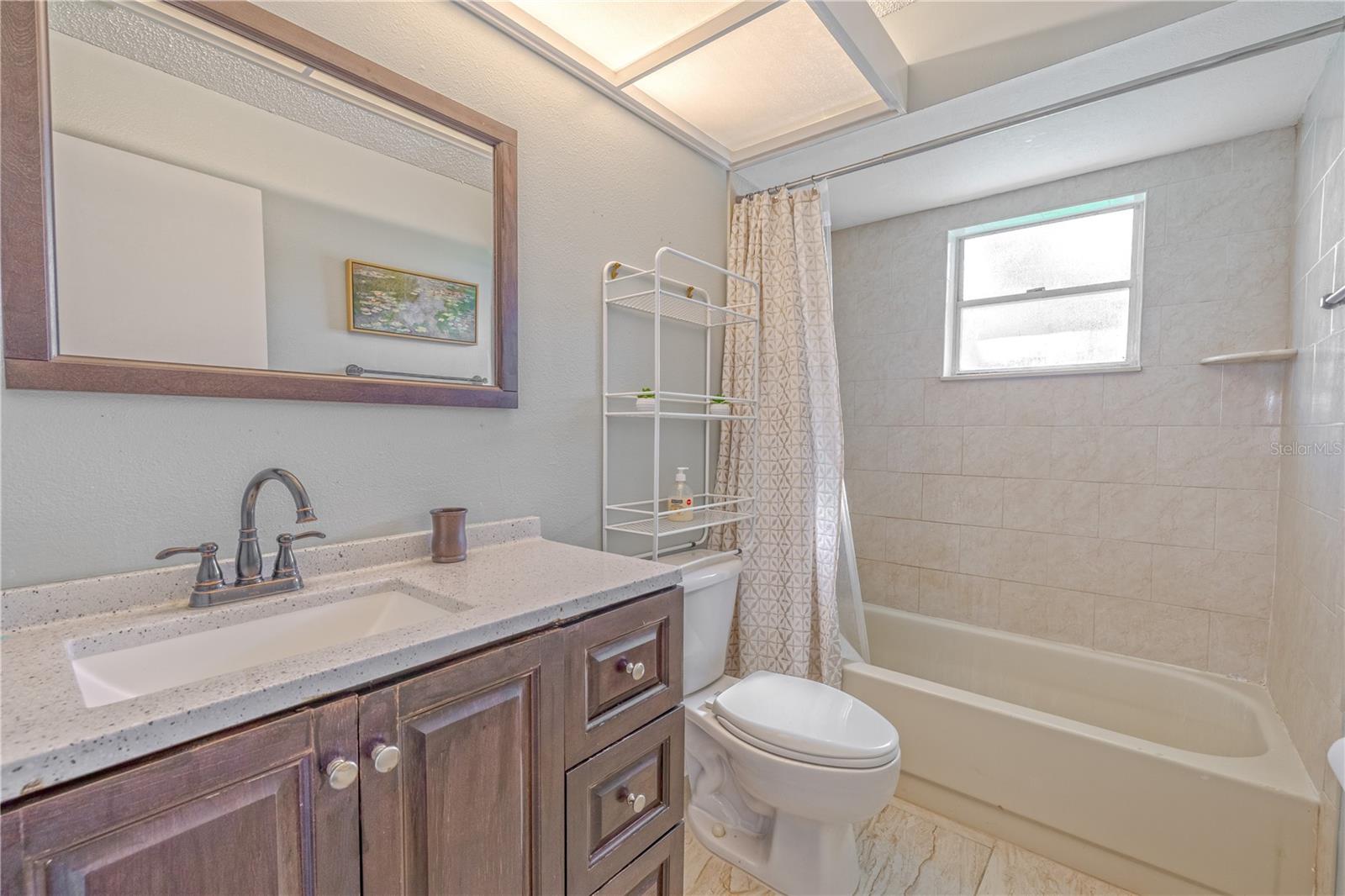 Original second bathroom with a tub-and-shower combo, offering a functional space ready for your personal touch and updates.