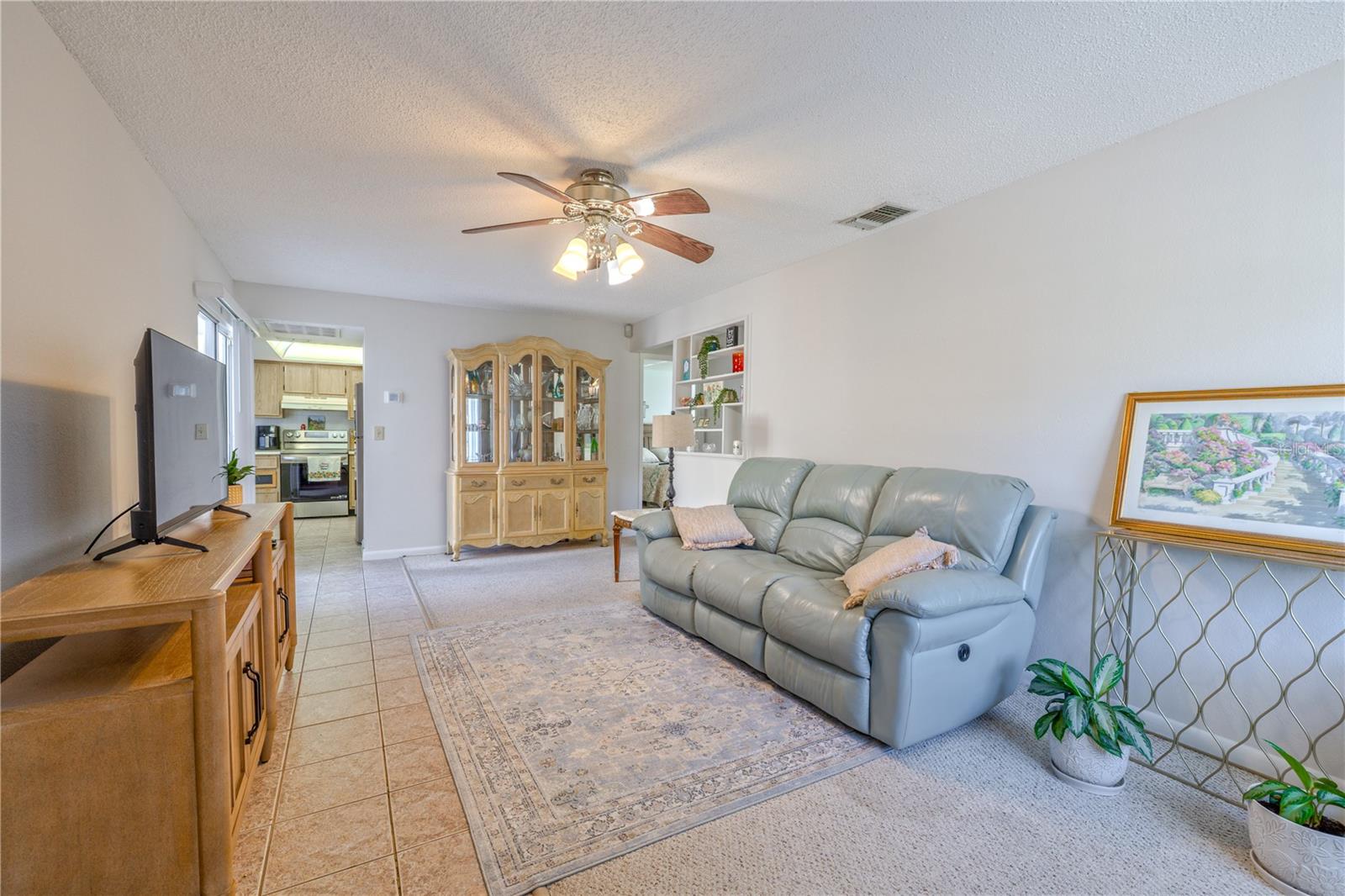 Spacious living area with natural light and a built-in wall niche that adds both character and storage.