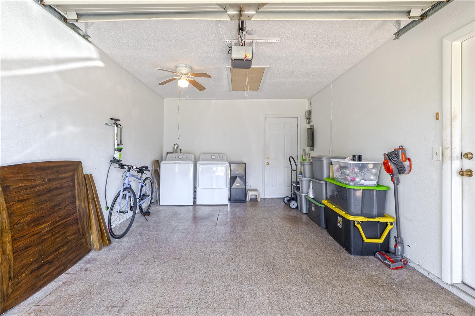 One-car garage with attic access for storage and an estimated 2022 washer and dryer included.