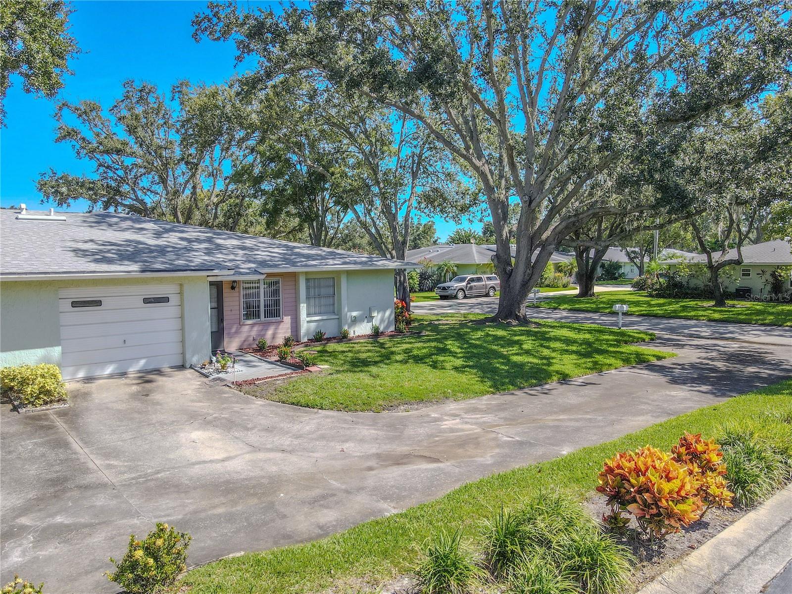 Mature landscaping and a welcoming front entry enhance the villa’s curb appeal.