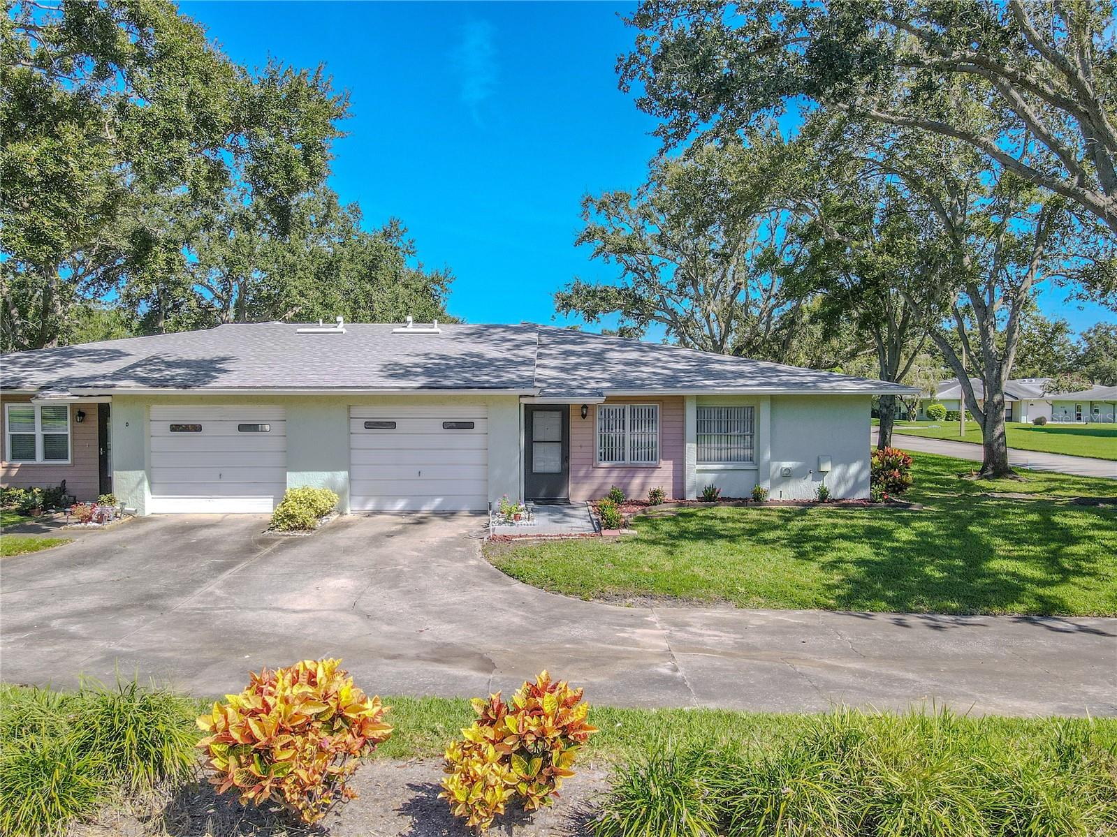 Ample driveway space and single-car garage provide both parking and functionality.