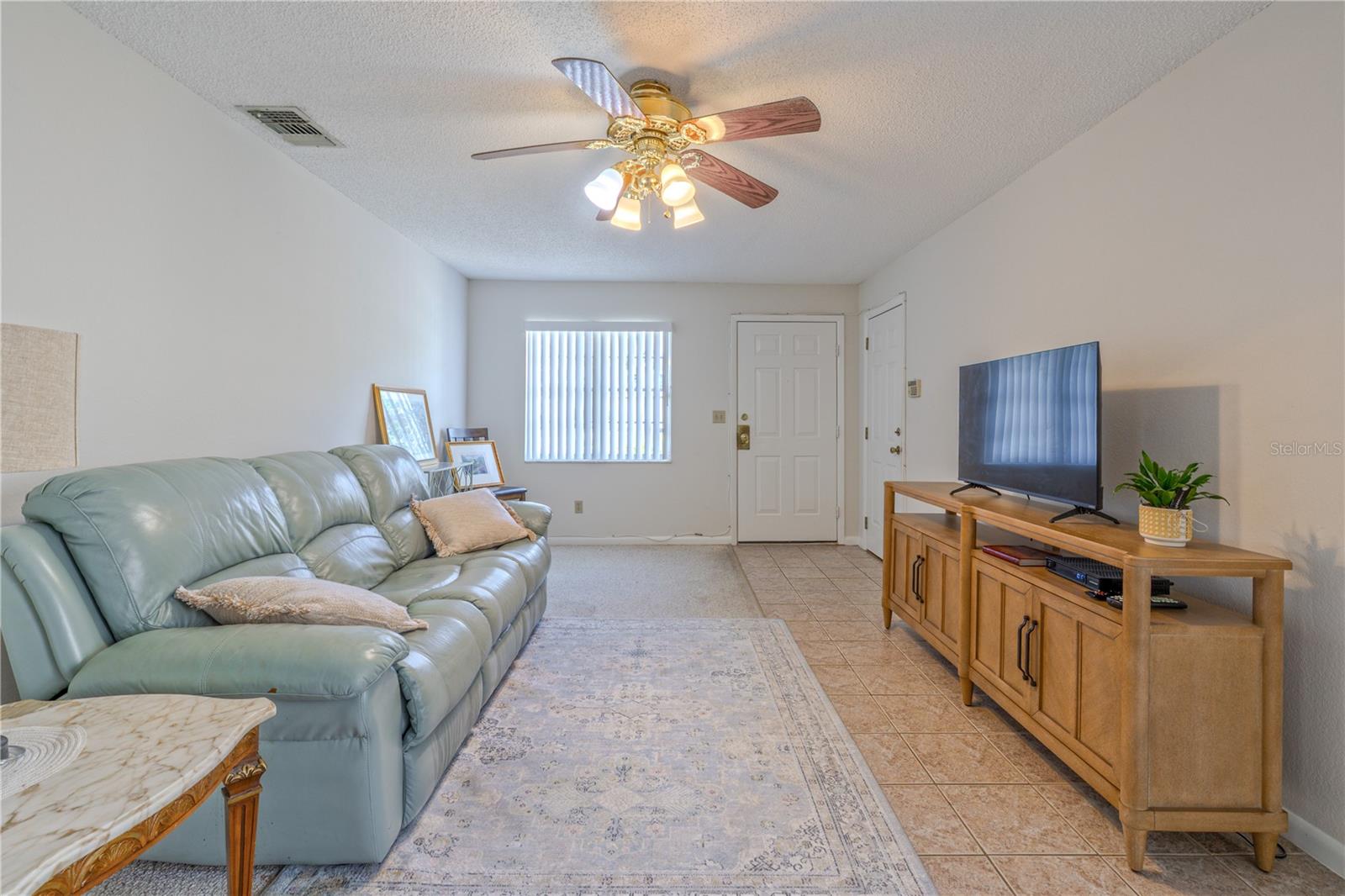Comfortable living space highlighted by soft carpet underfoot and plenty of room for seating.
