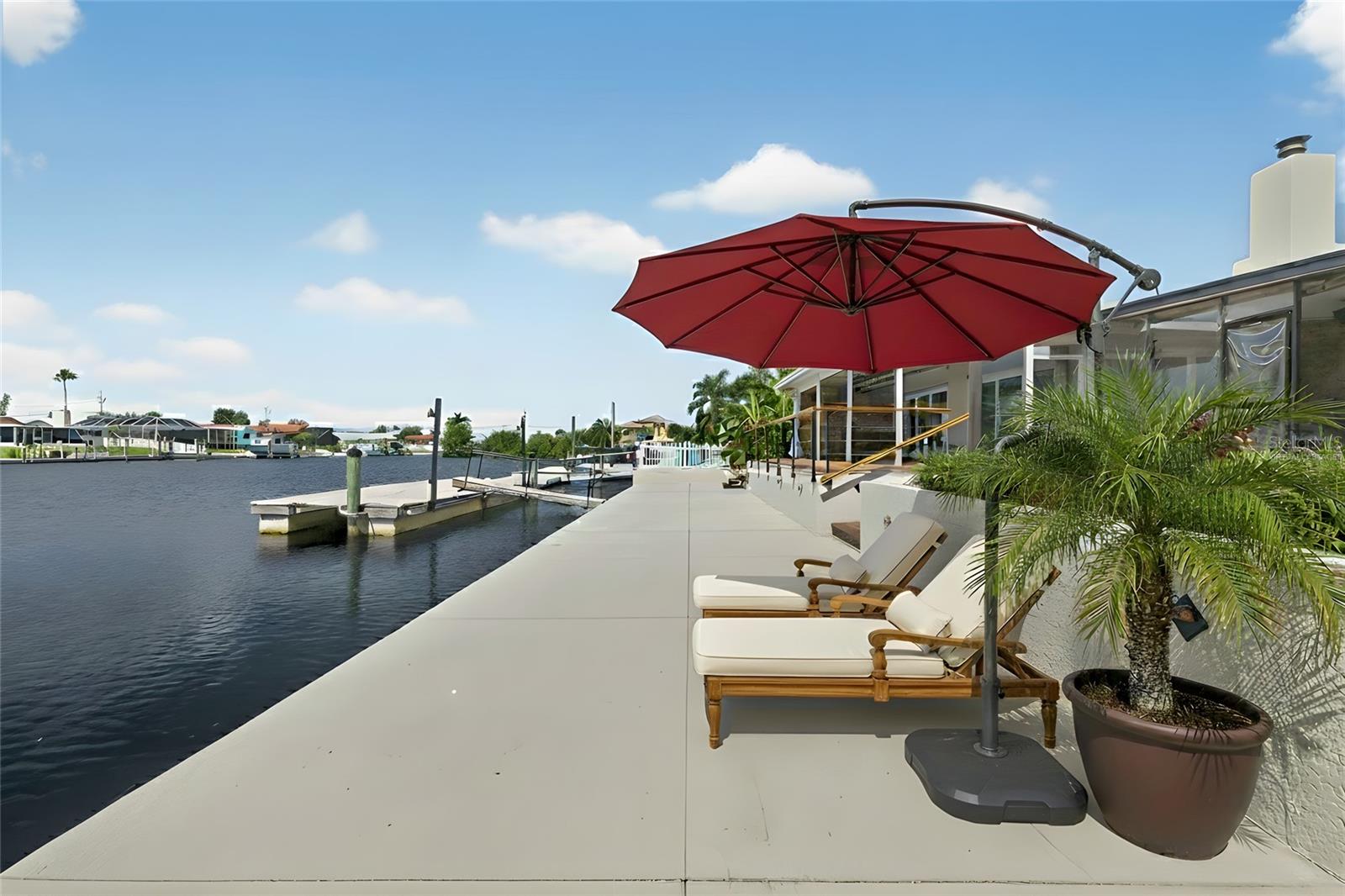 Virtually staged photo-canal seawall level lounge area