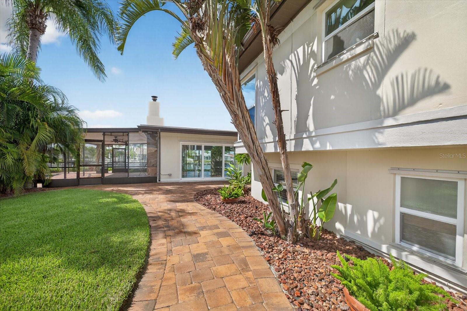 walkway to front door and screened pool area