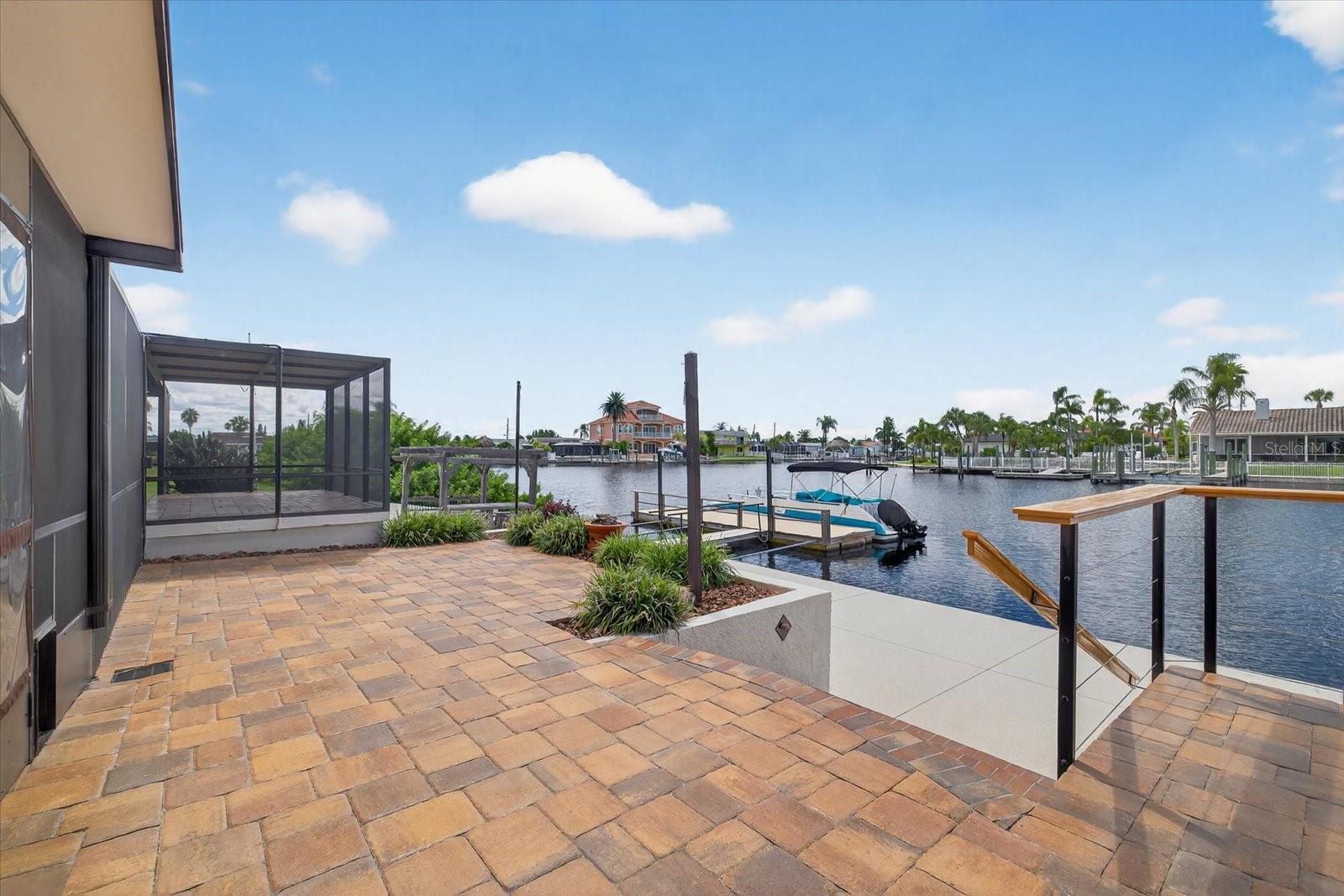 Steps down to seawall and floating docks.