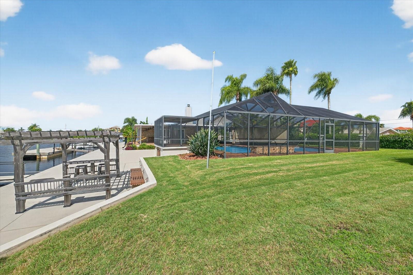 Backyard on double lot and view of pergola