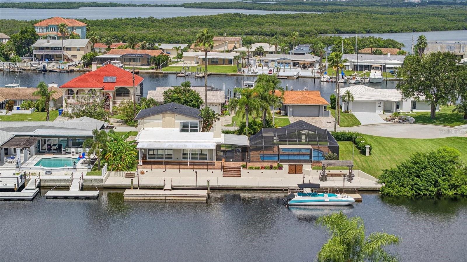 Back view of home with two floating docks and 120 ft seawall.