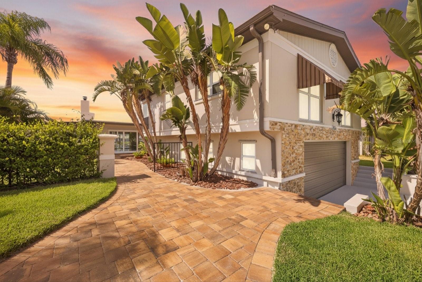 Twilight view walkway to front entry and lower garage view.