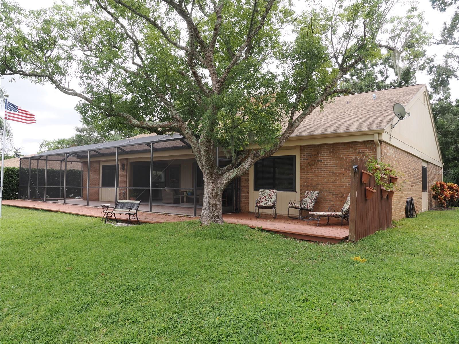 Rearview of home with an extended outdoor patio, great place to sit in the sun or grill out