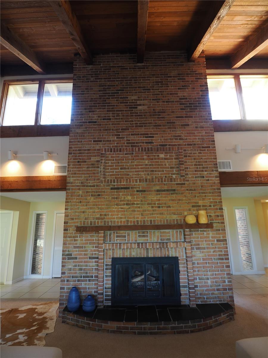 Double windows, frame this wood burning fireplace