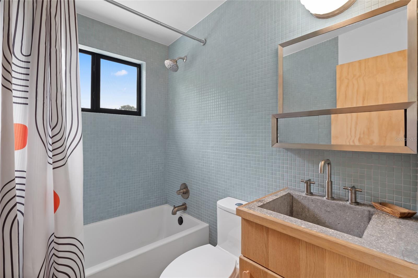 Custom concrete and wood vanity. Completely remodeled bathroom.