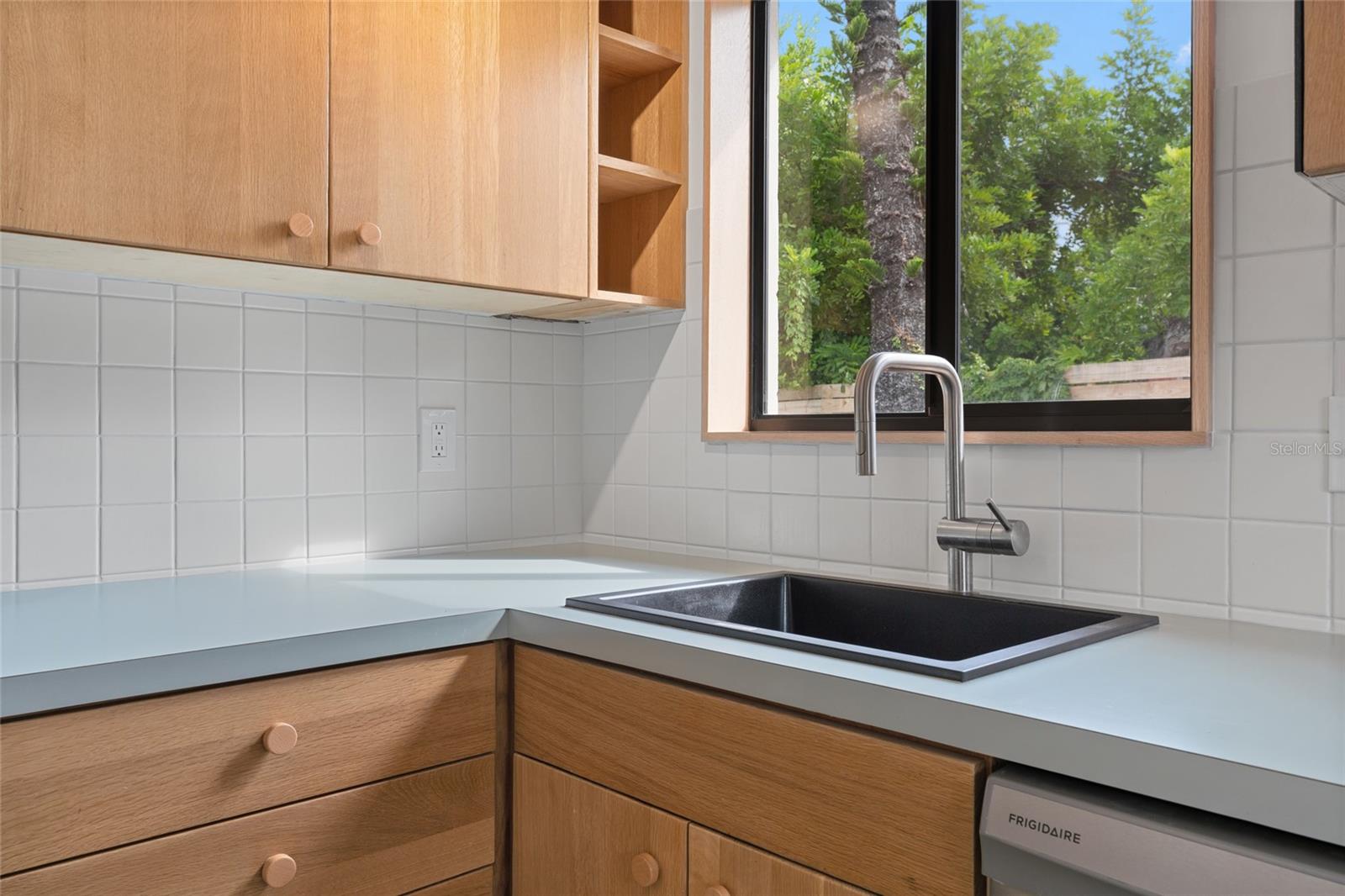 Fully renovated kitchen featuring Kraus sink, new Frigidaire appliances and wood cabinets.