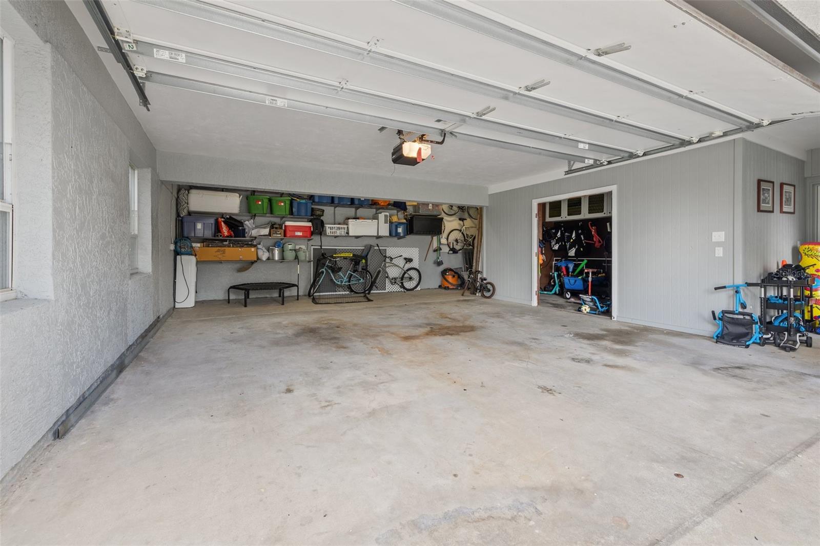 Two car garage with extended storage space and side storage room.
