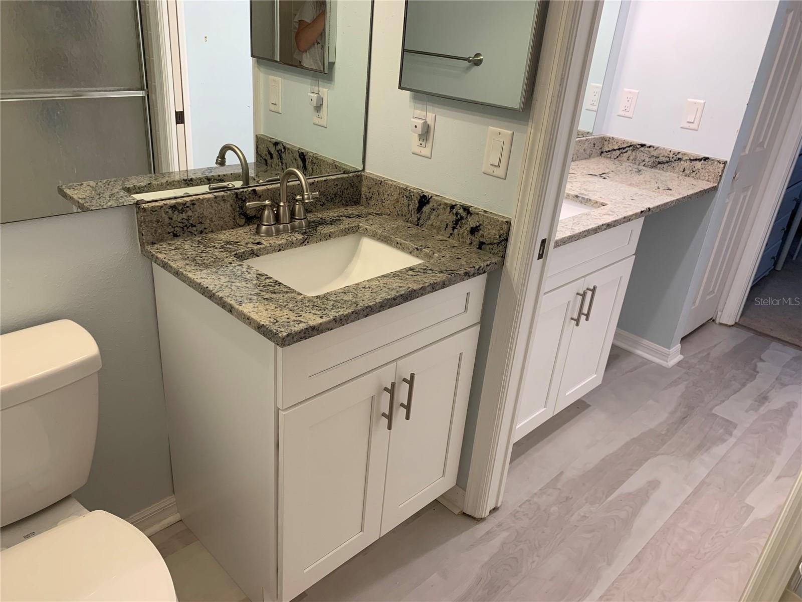 Primary En-Suite features a pocket door separating the two sink areas,