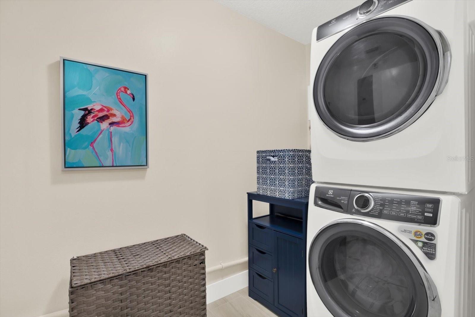 Laundry room with stackable Electrolux washer and dryer.