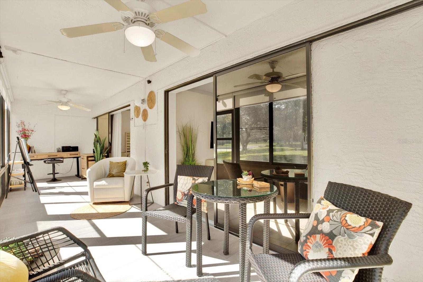 Tiled florida room with two sets of pocketing sliders.