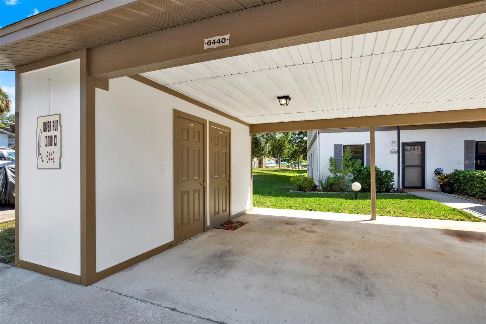 Covered parking with a spacious storage closet.