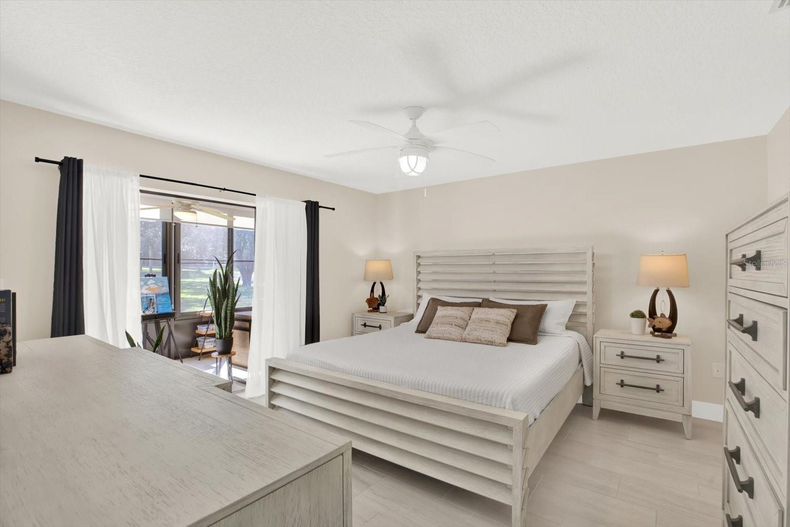 Spacious primary suite with sliders to the florida room.