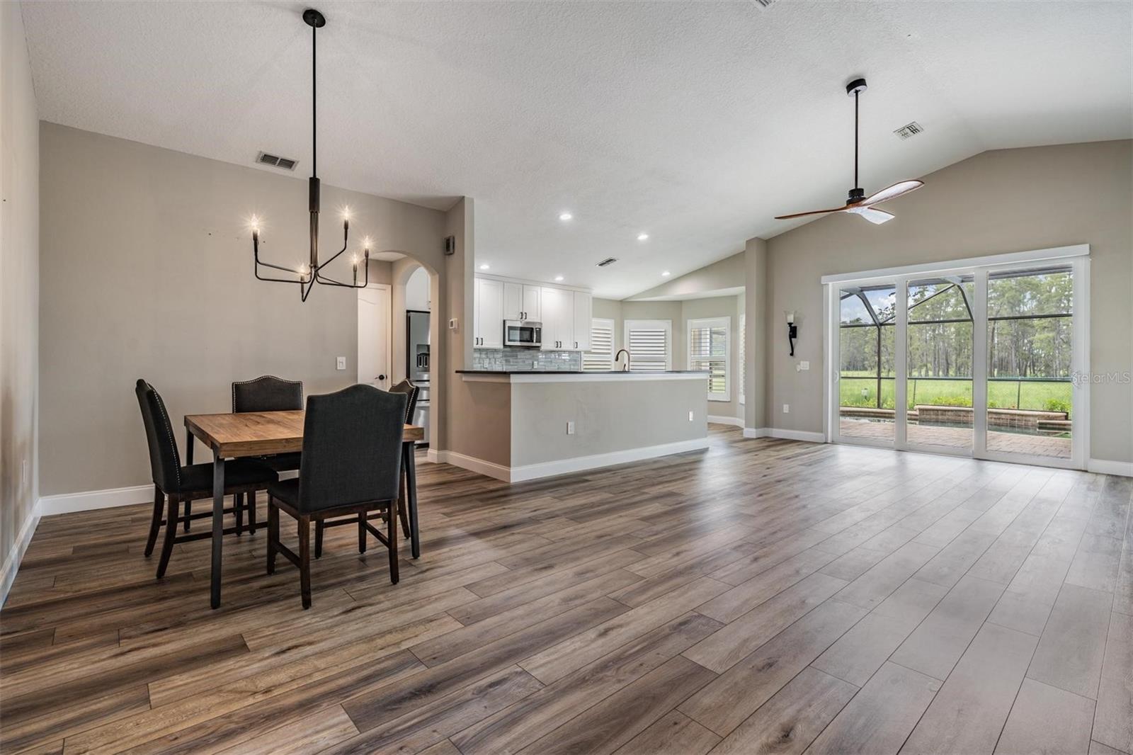 Great room with lanai and tree-line view