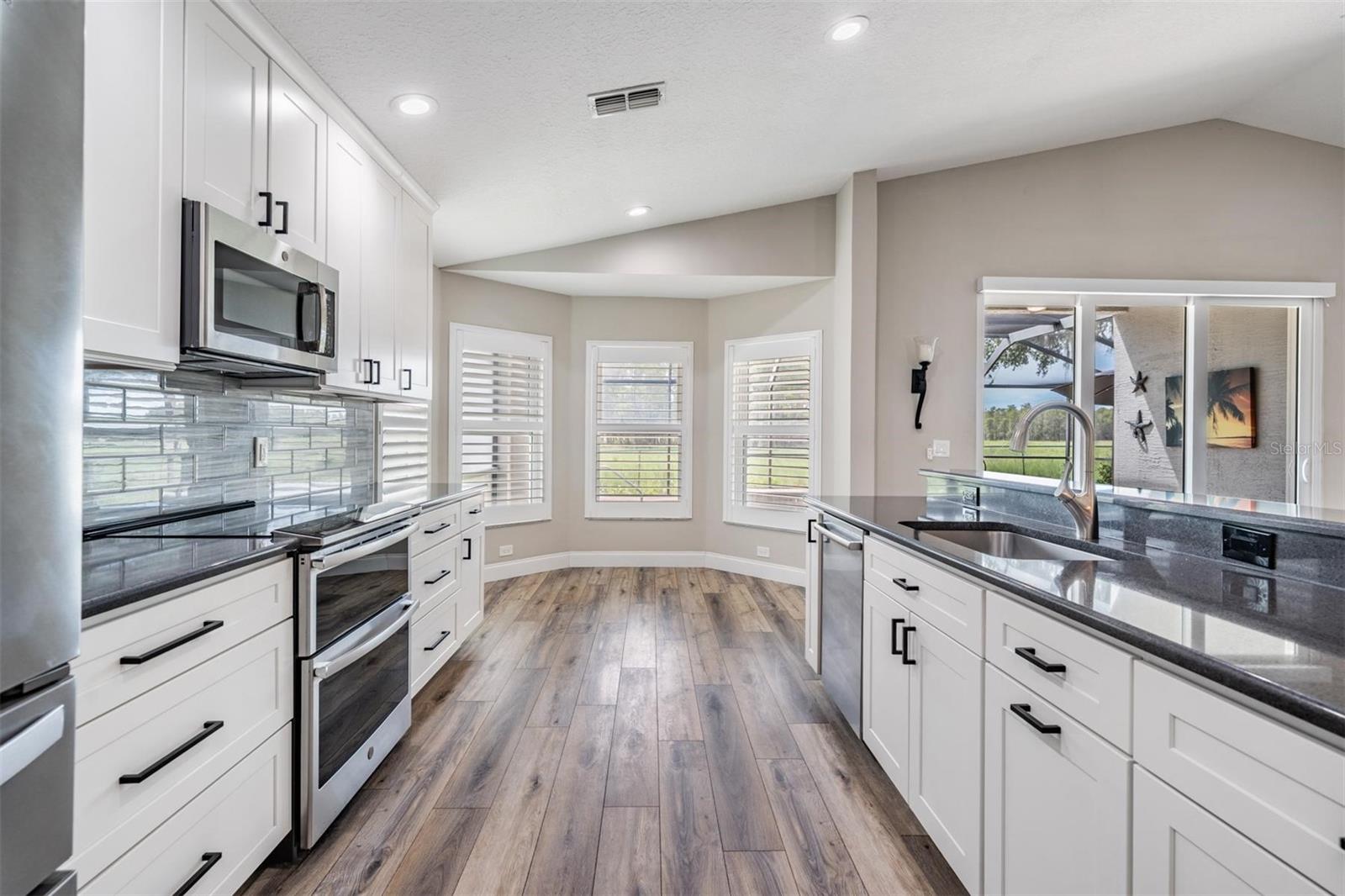 The kitchen nook is a great place to start your day. Plantation shutters throughout the home.