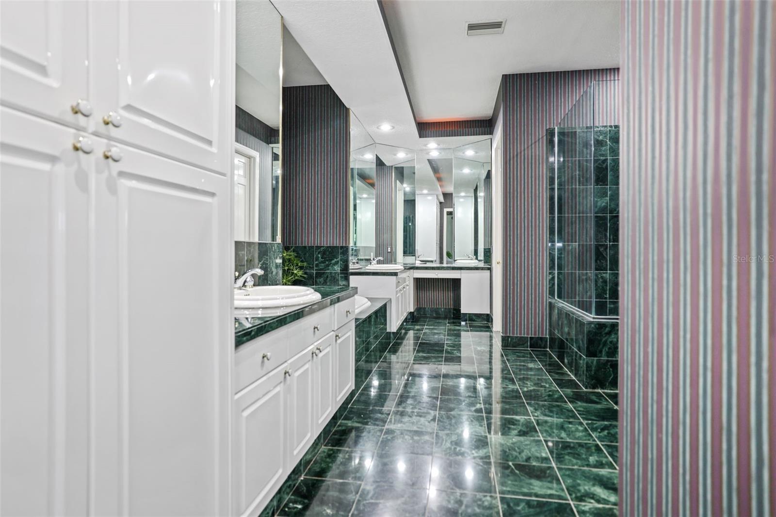 Primary Bathroom with Double Vanities, Tub, Shower and Water Closet